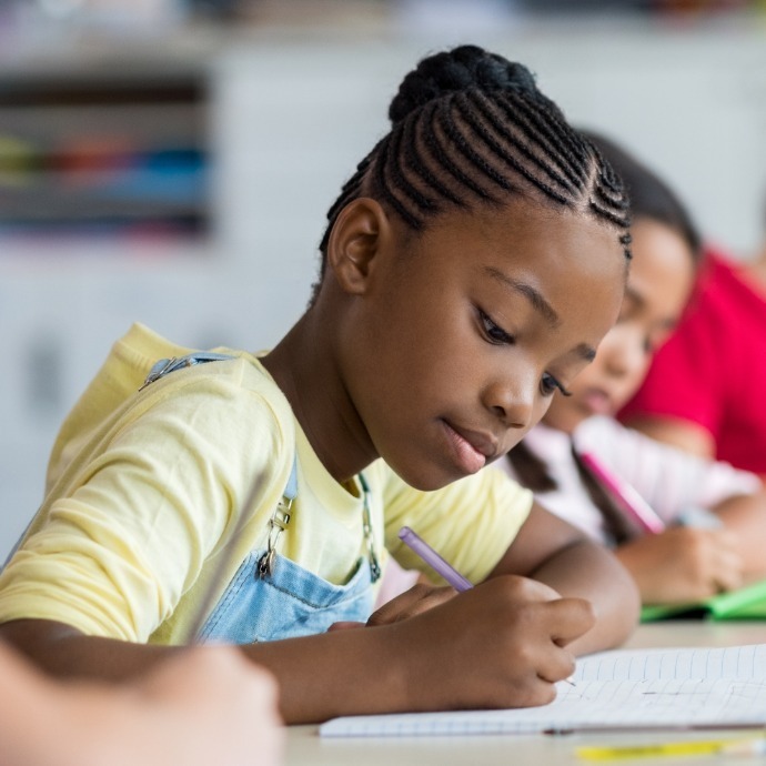 Children learning functional literacy skills in school